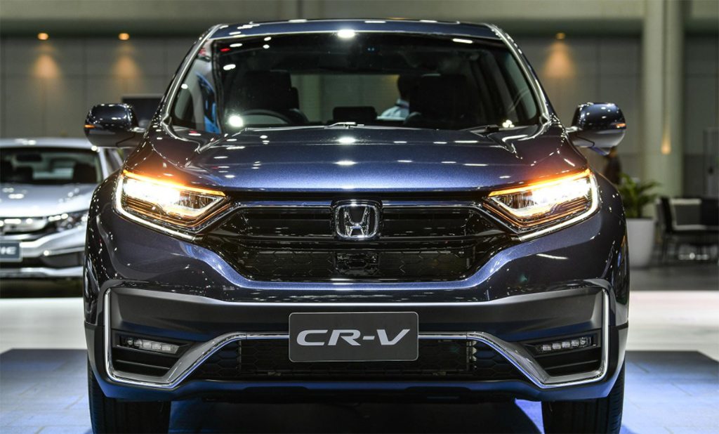 A black 2022 Honda CR-V with its headlights on.