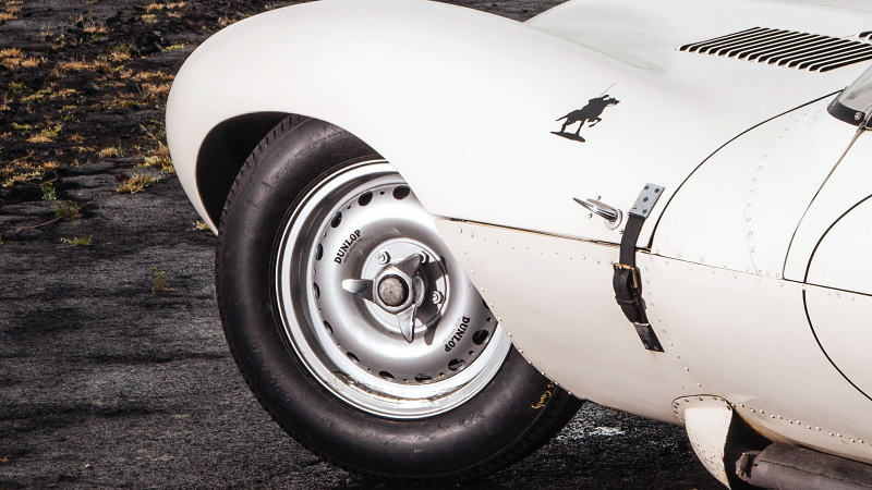 The tire and rim of a classic Mustang car.
