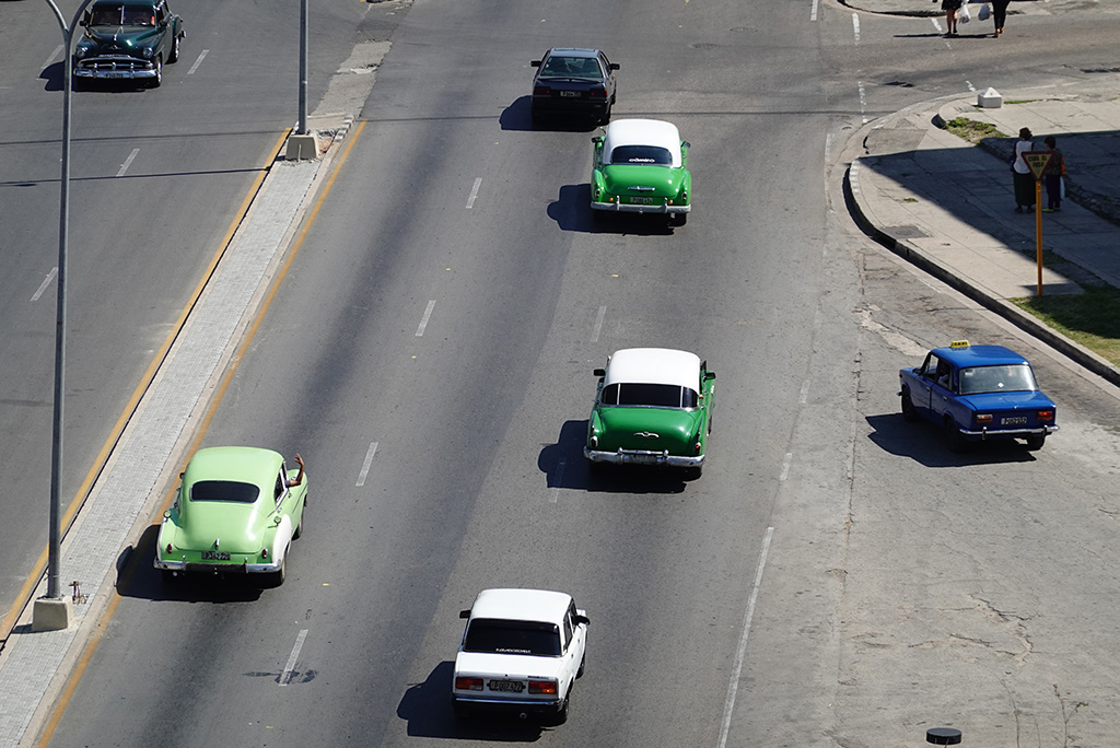 Cars on a freeway headed out of state. 