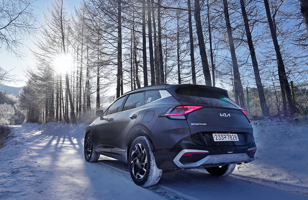 A Kia Sportage SUV on a snowy road.