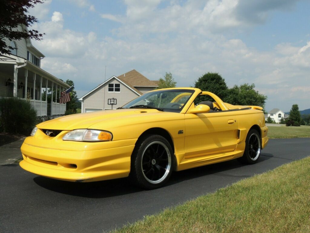 A yellow 1994 Ford Mustang GT.