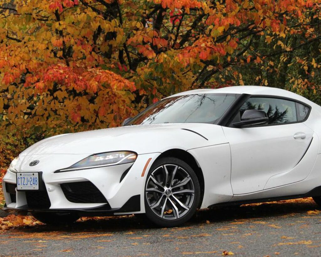 A white 2022 Toyota GR Supra 2.0 parked by some trees