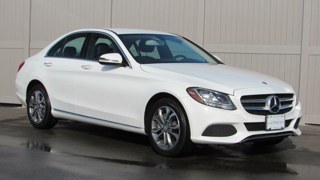 A used white 2016 Mercedes Benz C class C 300 4Matic car.