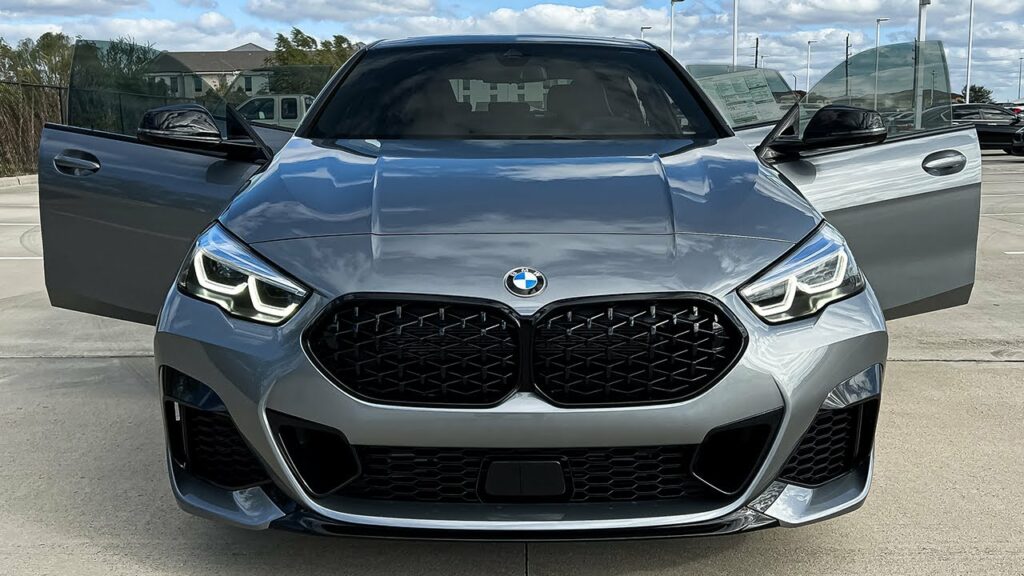 A parked silver BMW M235i Gran Coupe with its front doors open
