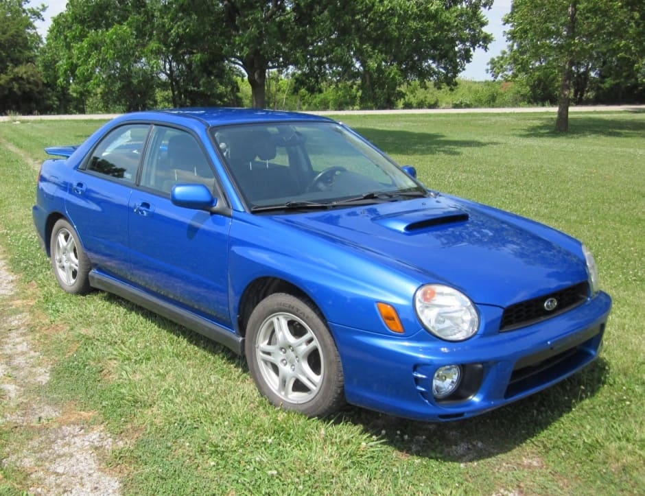 A parked blue 2002 Subaru Impreza WRX
