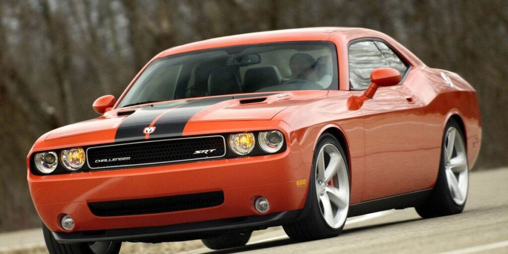 A parked orange 2008 Dodge Charger SRT8 with black trim