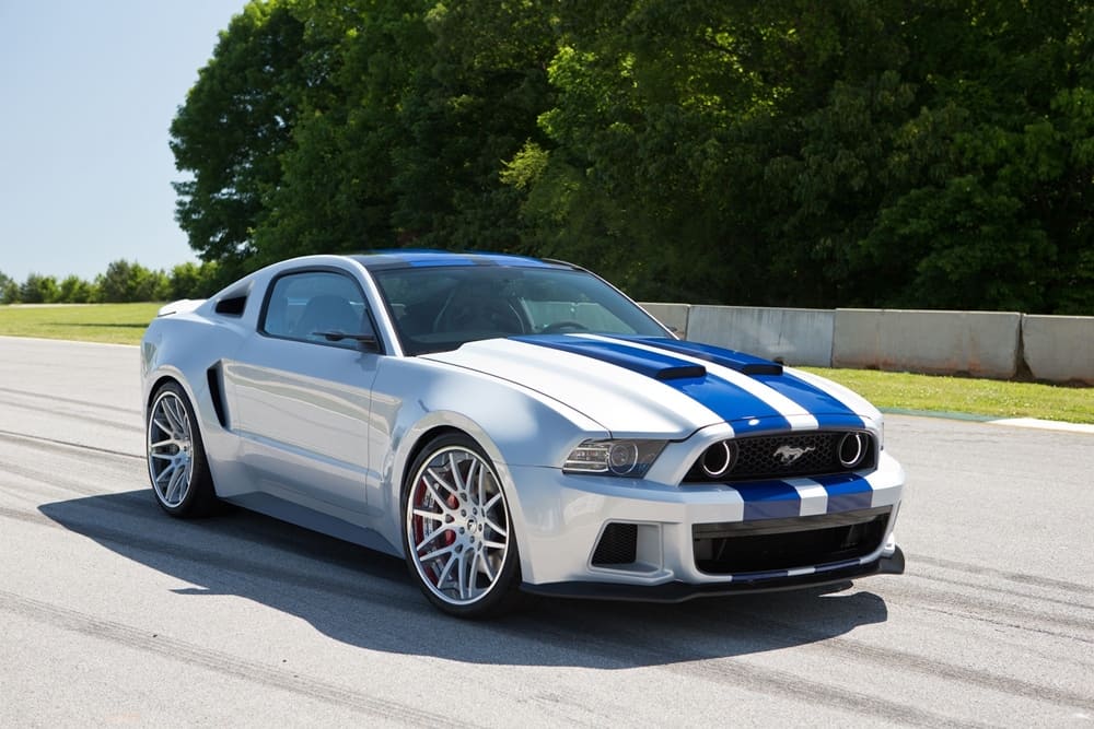 A silver 2014 Ford Mustang GT with blue trims on the move