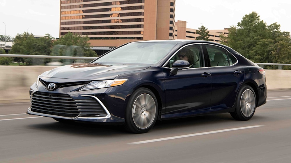 A black 2022 Toyota Camry on the move