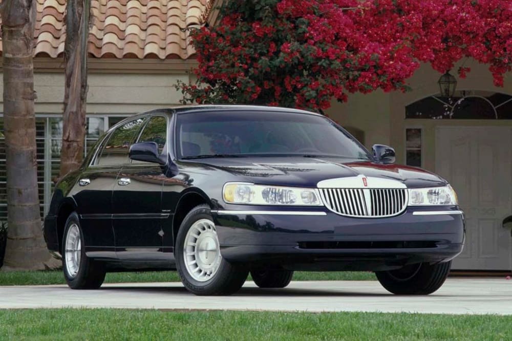 A parked black 1998 Lincoln Town Car