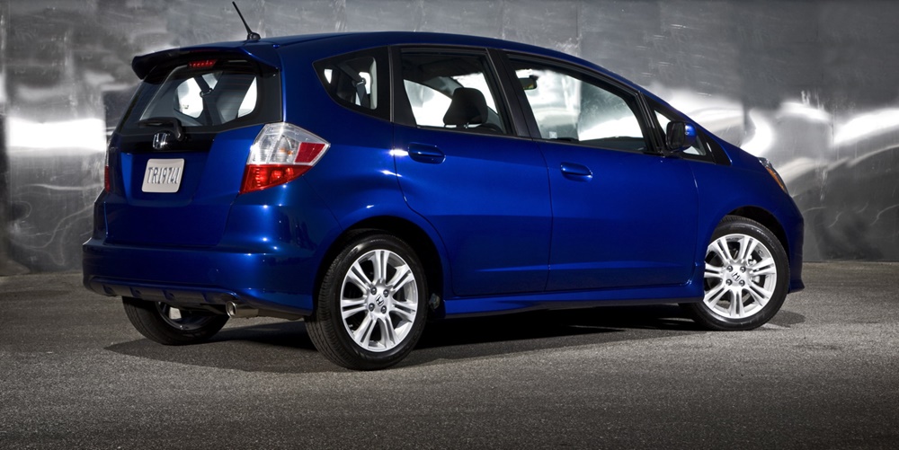 A parked blue 2010 Honda Fit