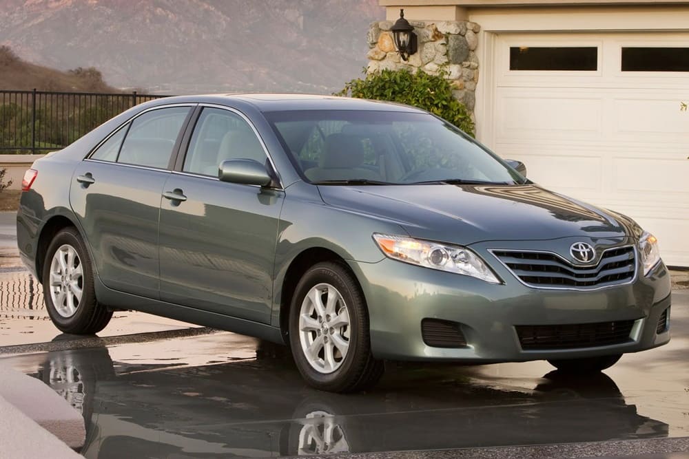 A parked teal 2010 Toyota Camry