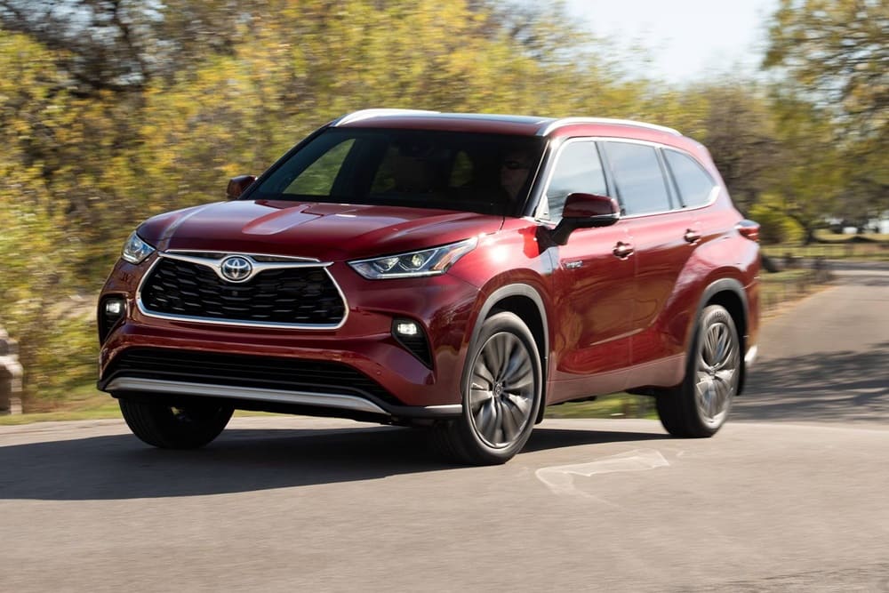 A red 2020 Toyota Highlander taking a corner