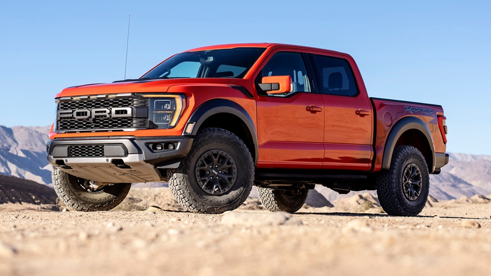 A parked orange 2022 Ford F-150 Raptor R