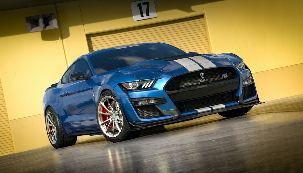 A parked blue 2022 Ford Mustang Shelby GT500 with white racing stripes
