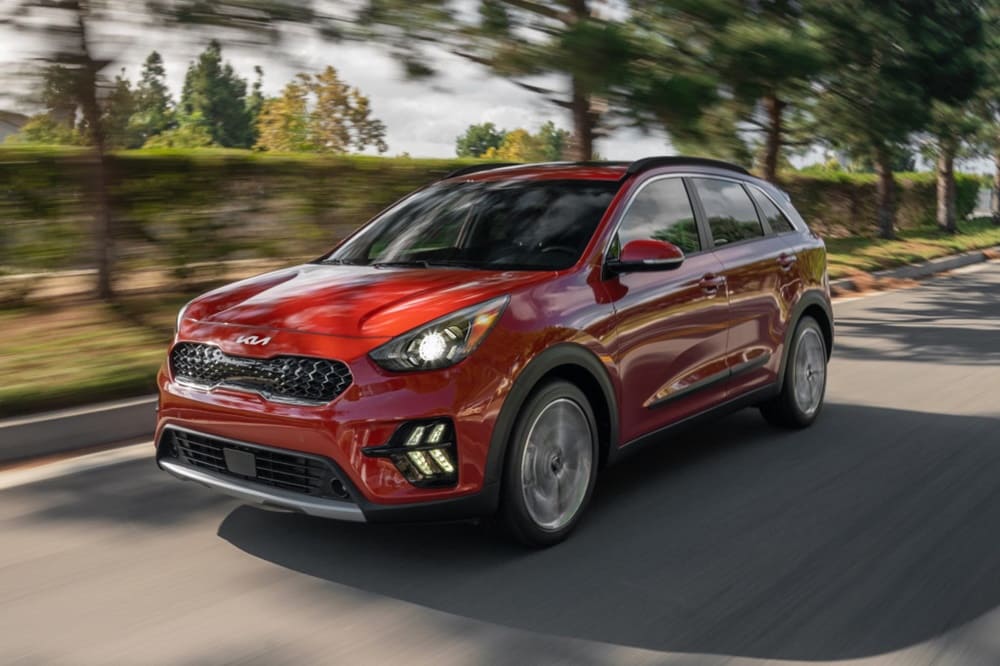 A red 2022 Kia Niro on the move