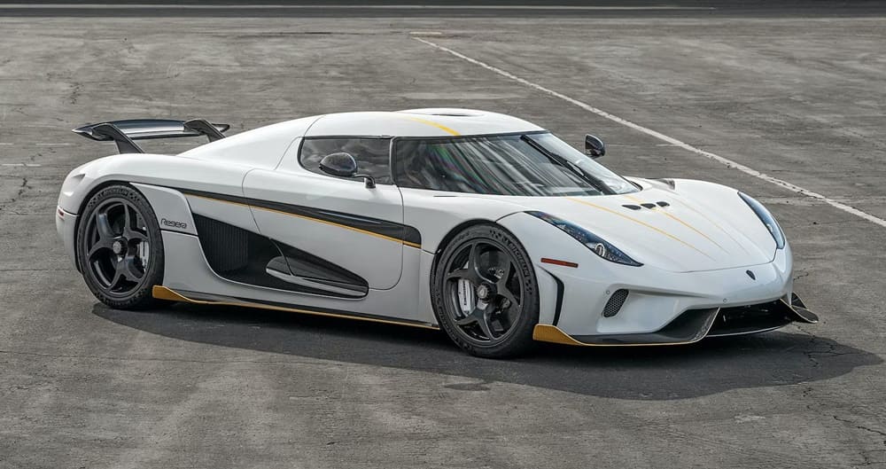 A parked white 2022 Koenigsegg Regera with racing decals