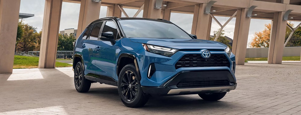 A parked dark blue 2022 Toyota RAV4 Hybrid