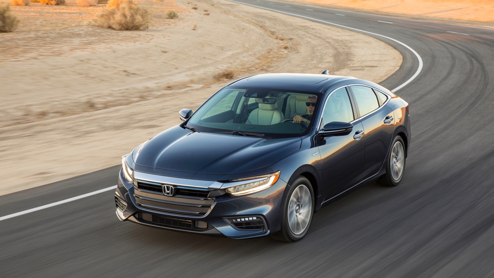 A black 2022 Honda Insight moving down a road