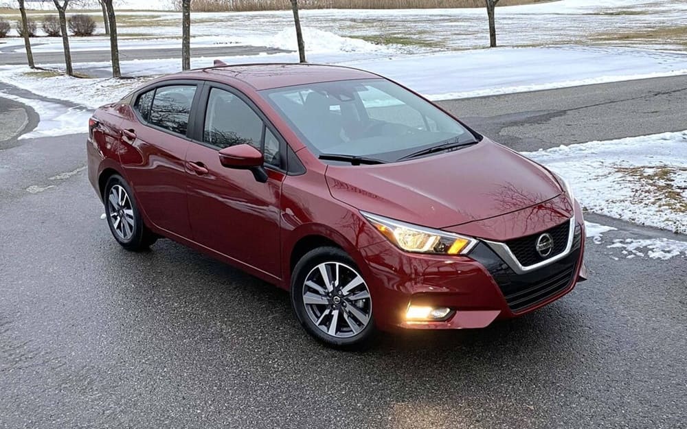 A parked red 2022 Nissan Versa in the snow