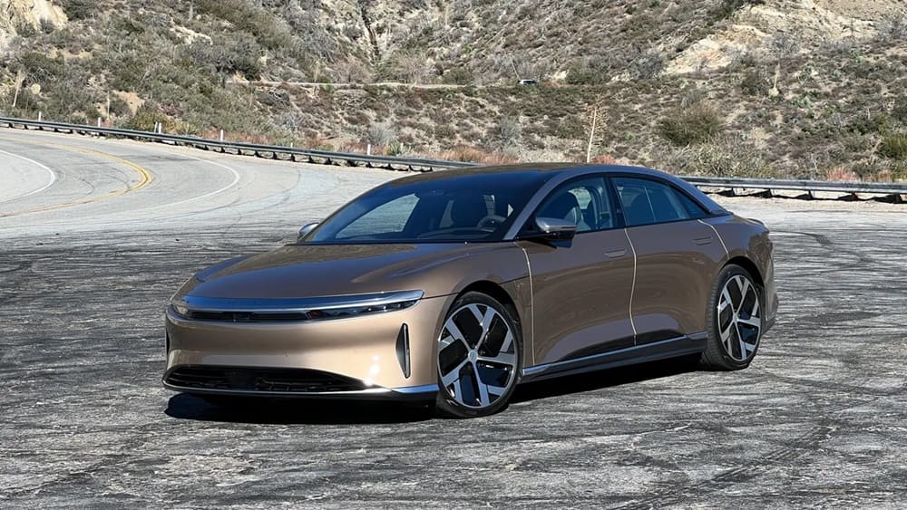 A parked 2023 Lucid Air Dream Edition Performance in Eureka Gold