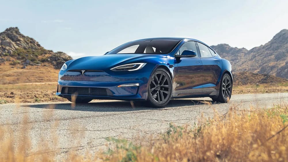 A blue 2023 Tesla Model S Plaid on the road
