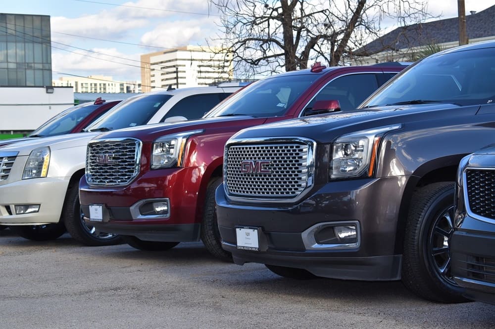 A line of pre-owned vehicles at a used car dealership