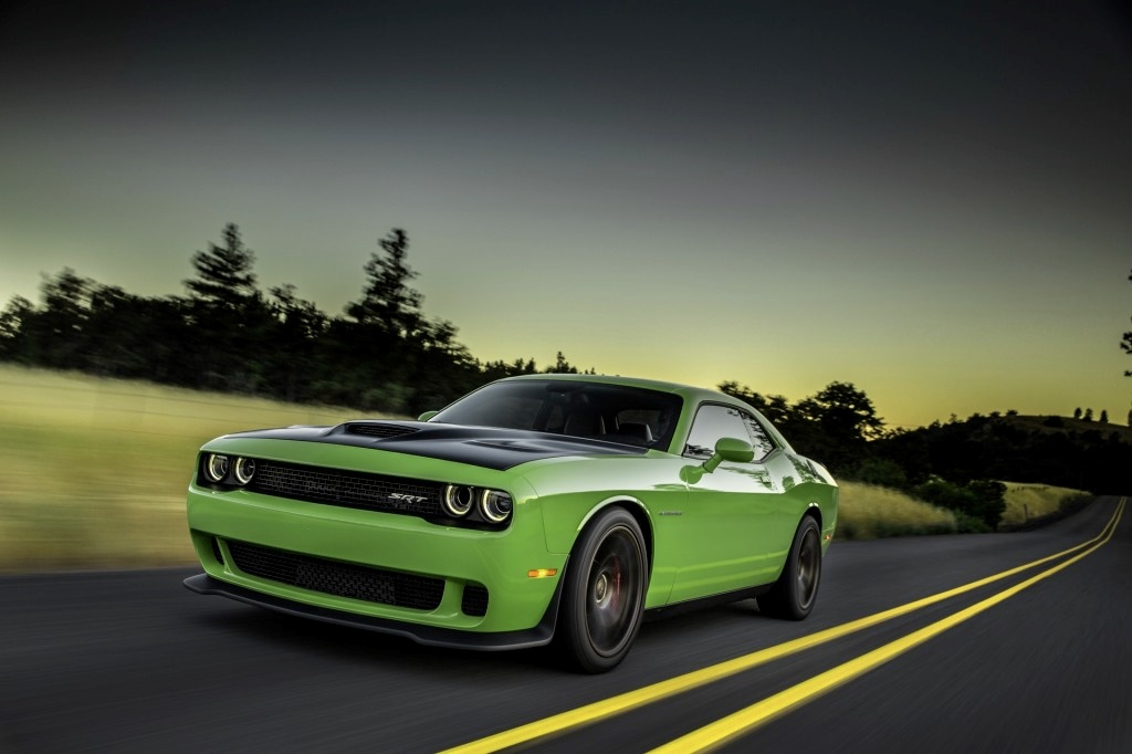 A green 2015 Dodge Challenger on the road