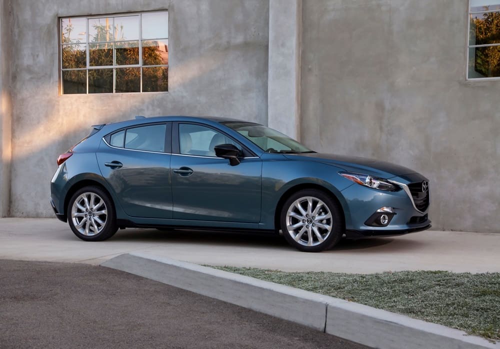 A parked dark blue 2015 Mazda 3