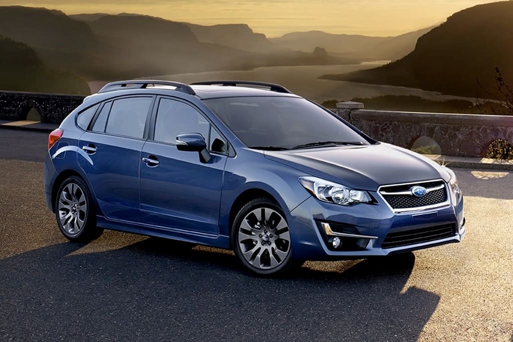 A parked blue 2016 Subaru Impreza hatchback