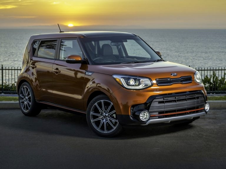 A parked golden orange 2018 Kia Soul