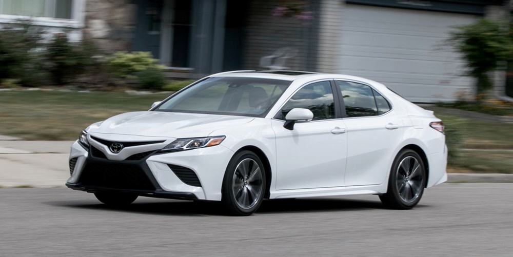 A white 2018 Toyota Camry on the move