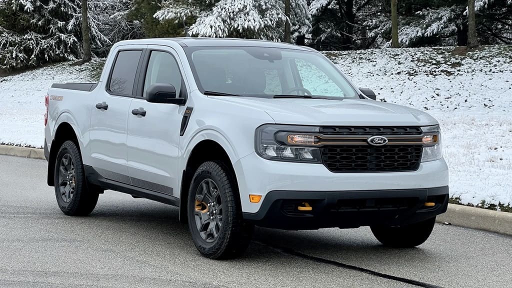 A parked white 2023 Ford Maverick in snow