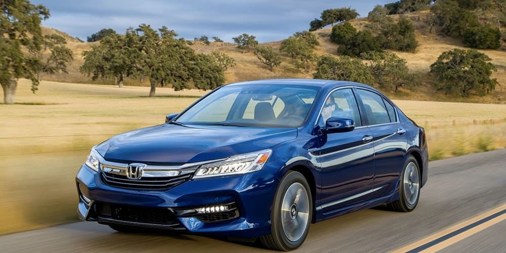 A blue 2017 Honda Accord Hybrid driving down the road