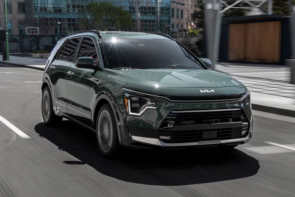 A dark green 2023 Kia Niro on the move