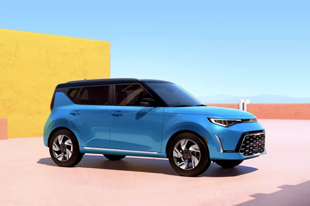 A parked blue 2023 Kia Soul with a colorful backdrop