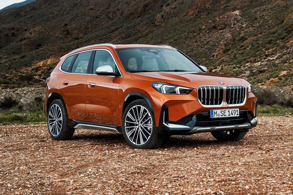 A parked orange 2023 BMW X1