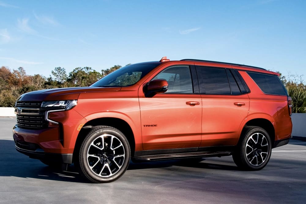 A parked bright orange 2023 Chevrolet Tahoe