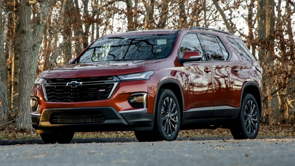 A parked reddish-orange 2023 Chevrolet Traverse