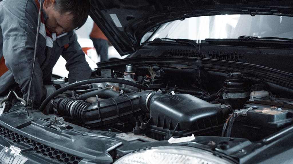 A mechanic inspecting a car's internals