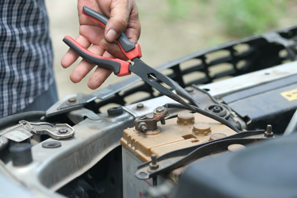 A man checking a car battery