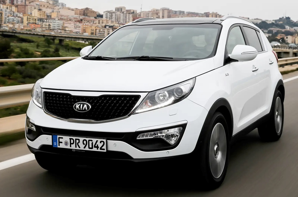 A white 2014 Kia Sportage on the road