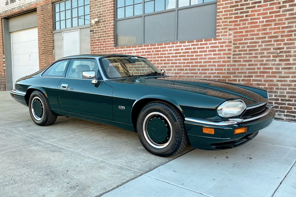 A parked teal 1994 Jaguar XJS